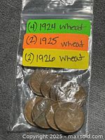 Front view of sealed bag containing eight wheat cents with handwritten year counts
