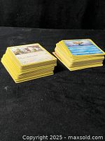 Two stacks of yellow-border Pokémon cards