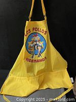 Full view of yellow apron showing entire shape and ties