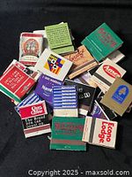 Top-down view of pile of advertising matchbooks showing various hotel and casino logos