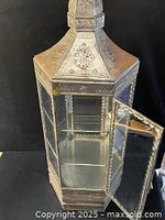 Full front view of metal and glass cabinet with door open