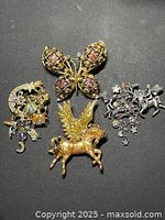 Group shot of four fantasy theme brooches