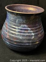 angled view of vase showing ribbed body and galaxy paint