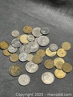Overview of mixed foreign coins spread on surface