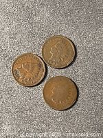 Obverse sides of three Indian Head cents dated 1899, 1902, 1903