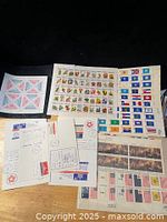 Overview showing multiple stamp sheets and souvenir cards