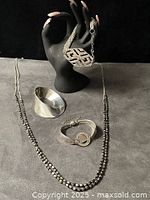 All items in lot: necklace, three bracelets displayed