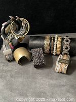 Group view of all bracelets displayed on hand and tube stands