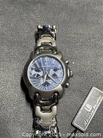 Front view showing dial, case design and hang tag