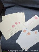 Assortment of unused U.S. postal cards and stamped envelopes on fabric background