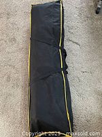 Zippered black canvas carry bag closed