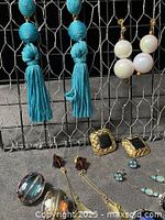 Full view of all seven earring pairs hanging and laid out