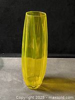 Full view of neon yellow glass vase standing upright on surface