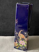 Front view of cobalt blue rectangular vase with hand painted peacocks and flowers