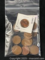 Plastic bag with loose wheat pennies and one coin in cardboard flip