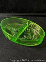 Top view of oval uranium glass dish showing divider and starburst pattern