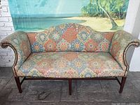 Front view of entire couch showing upholstery pattern, shape and legs