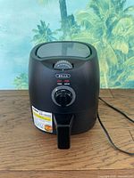 Front view of Bella air fryer showing analog controls and exterior condition