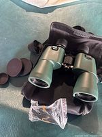 Binoculars in carry case with lens caps and strap