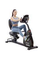 Marketing image of woman using the Circuit Fitness recumbent bike