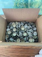 Open box showing numerous Mr. Pibb bottle caps
