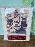 Full view of signed photo mounted on faux-marble plaque