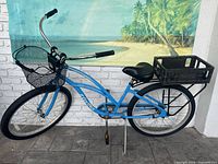 Full right-side view of blue Electra beach cruiser with front mesh basket and rear crate basket