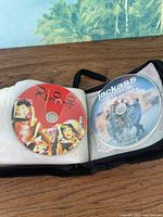 Disc wallet open showing DVDs 20 30 40 and Jackass: The Movie