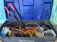 Open Kobalt toolbox showing bolt cutters, rake, cords and misc items