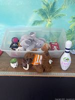 Overall lot: tote with books and stuffed animals, mammoth plush, hedgehog planter with faux succulent, souvenir bowling pin