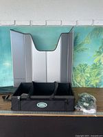 All three items displayed: cargo organizer, silver sun shade, sealed tie-down kit