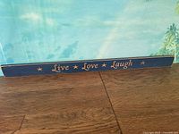 Full view of wooden sign showing text and color