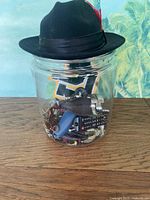 Jar with contents and fedora hat