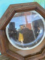 Full view of octagonal wood frame containing round Norman Rockwell plate