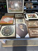Overview showing all eight framed pictures on table