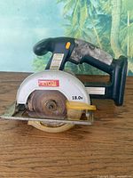 Left side view showing Ryobi logo, 18.0V marking, blade and guard