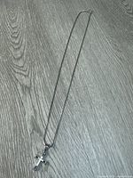 Full view of sterling silver chain and cross pendant