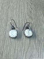 Front view showing faceted mother-of-pearl stones and hooks