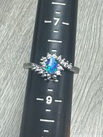 Front view of ring on mandrel showing opal and CZ halo