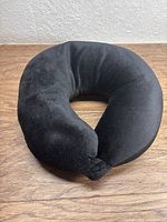 Full view of black U-shaped travel pillow