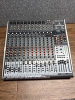 Full view of Behringer X2442USB mixer showing all controls and faders