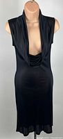 Full front view of black sleeveless cocktail dress on mannequin