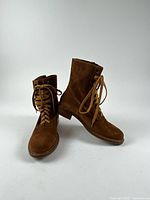 pair of brown suede/leather lace-up boots facing front and side