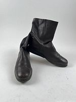 Front three-quarter view of both boots showing uppers and toe condition