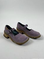 Side view of both shoes showing strap, suede uppers and heel condition