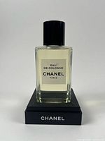 Front view of Chanel Eau de Cologne bottle on display base
