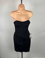 Front view of black strapless Dolce & Gabbana cocktail dress on mannequin