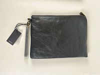 Front view of ECCO black leather wristlet clutch with tags attached