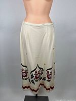 Full view of cream embroidered skirt on mannequin