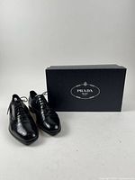 Pair of shoes with Prada box frontal view